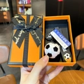 Detail of football keychain set with goal strap and bus stop sign in a gift box - Black & White Football + Next Station Sign + Gift Box