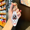 Macro detail of diamond-shaped acrylic billiard keychain with 8-ball and snooker print - White Sports - Billiards