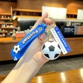 Blue football keychain with silicone wrist strap and metal ring charm decoration - Football with Road Sign