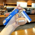 Rugby keychain with brown ball pendant and blue silicone wristband for sports fans - Rugby with Road Sign