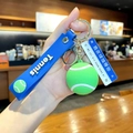 Tennis keychain featuring a green mini ball with a blue silicone wristband and clip - Tennis with Road Sign