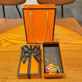 Macro view of gold trophy pendant and flag soccer ball keychain in luxury gift packaging - Flag Soccer Ball + Gold Trophy + Lobster Clasp + Gift Box + Bag