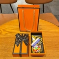 Detailed close-up of a soccer trophy keychain set with luxury orange gift packaging - Soccer Ball + Trophy + Sign + Yellow Braid + Gift Box + Bag