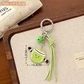 Porte-clés tennis en acrylique avec visage souriant et petit grelot vert mignon - Balle de tennis