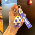 Cartoon soccer keychain with orange headphones and a blue purple sport wrist strap - Dark Blue Headphone Style