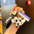 Soccer ball keychain with white wings and black 'SPORT' wrist strap in golden hardware - Angel Black and White Style (With Sign)