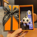 Cartoon soccer player keychain with blue strap in elegant orange gift box with bow - World Wave Blue Style With Gift Box