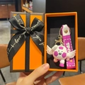 Cartoon soccer doll keychain with wings and pink strap in an orange gift box - Angel Purple Style With Gift Box
