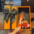 Handheld gift box featuring a cute basketball player keychain with an orange sport lanyard - Basketball Style + Orange Gift Box