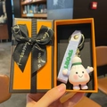 Cartoon badminton figurine keychain with pink cheeks and purple sport wrist strap - Badminton Style + Orange Gift Box