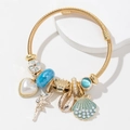 Pulsera de cuerda dorada con dijes de corazón de perla, concha y hada con cuentas azules - Azul