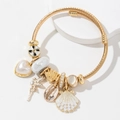 Pulsera dorada de acero inoxidable con dijes de corazón de perla, concha y hada - Blanco