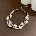 Three-strand baroque pearl bracelet with adjustable metal clasp on dark background - 03-I 7 White Pearl Bracelet Multilayer Design