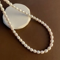 Elegant natural baroque pearl necklace with high luster on a geometric display stand - 06-K7 Natural Pearl Necklace 6-7mm