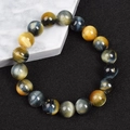 Macro shot of 8mm tiger eye stone beads with natural texture on a marble base - Mixed Fantasy Tiger Eye