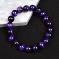 Macro detail of 8mm purple tiger eye beads showing natural fibrous texture and high gloss - Purple