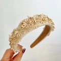 Close-up of a cream thick headband featuring 3D daisies with sparkling rhinestones - Beige