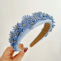 Detail of light blue leather headband featuring rhinestone flowers and soft texture - Blue