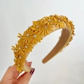 Macro detail of yellow fabric headband featuring leather daisies and sparkling rhinestones - Yellow
