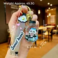 Detail of panda liquid keychain with blue sand, donut charm, and Sweet heart strap - Soda Bottle Snow Panda