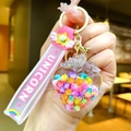 Detail of strawberry-shaped unicorn keychain with pink silicone strap and glitter filling - Glow-in-the-dark Rainbow Candy Beans [strawberry]