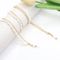 Elegant gold metal glasses chain with white spiral conch beads and silicone loops - Shell Charm Chain