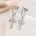 Macro shot of silver cross hoop earrings with sparkling pavé cubic zirconia inlay - 5