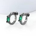 Close-up of gunmetal C-shape earrings with marquise green gemstones and screw-back detail - 16