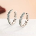 Macro shot of silver ear cuffs with irregular texture and light green enamel inlay - Uneven Texture Cyan Enamel Ear Cuff Style / One Pair / Silver/Cyan