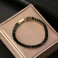 Vintage gold tennis bracelet featuring rectangular black zircon stones and a secure clasp - Gold Black