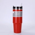 Close-up of red stainless steel insulated tumbler with a black lid and clear straw detail - Red