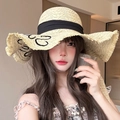 Detail of wide brim straw hat with black ribbon and elegant handwritten embroidery - Beige Letter Large Bow (D-509)