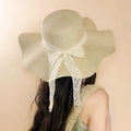 Close-up of the woven texture and white lace bow detail on a wide brim straw sun hat - Beige Leaf Label Straw Hat (D-579)