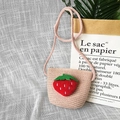 Detail view of pink straw crossbody bag for kids with cute plush strawberry decoration - Plush Strawberry - Pink
