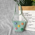 Detail of light green straw crossbody bag with colorful floral decorations and braided strap - Soft Flower - Green