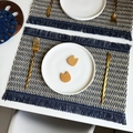 Detail van geweven placemat met visgraatpatroon en decoratieve franjes aan de randen - Beige & Blauw Geweven