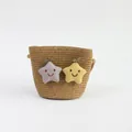 Close-up of a child straw crossbody bag with star patches and embroidered smile face - Smiling Star - Khaki