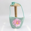 Detail of mint green straw bag for girls with a large pink sequin bow and doll charm - Mesh Girl - Green