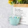 Detail of light green woven straw bag featuring colorful pompoms for children - Lace Color Balls - Green