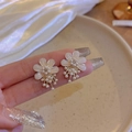 Elegant floral stud earrings with cream petals, gold base and delicate white pearls - Pearl Stud Earrings