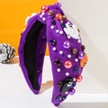 Detail of purple knitted headband with Halloween pumpkin, ghost, pearls and rhinestones - Purple