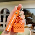 Vibrant orange EVA mini bag keychain with Forever Sports silicone wrist strap and metal ring - Orange