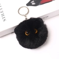 Detailed view of 8cm black fluffy plush cat head keychain with realistic orange eyes - Standard - Silver Ring / 8cm Black