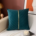 Detail of dark green velvet pillow with pleated chevron texture and gold accent trim - Malachite green