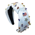 Detail of knotted headband with US flag theme and colorful rhinestones on white fabric - White