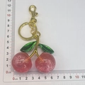 Red glitter cherry keychain with green leaves and gold metal hook on measuring scale - Gold Double Green Leaf Red Cherry