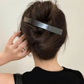 Close-up of a large minimalist metallic hair clip on a sleek bun hairstyle - Duckbill Hair Clips / Single Piece / Gunmetal