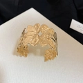 Detailed macro view of the intricate floral texture on this gold-toned open cuff bracelet - Multi-Layer Overlapping Leaf Style (59#) / Gold