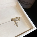 Detail shot of a gold-plated ear cuff with sparkling zircon cross charm in a jewelry box - Gold Double-Layer Cross Ear Bone Clip (5#) / Single Piece