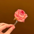 Detailed view of a handmade pink rose flower hairpin featuring realistic silk petals - Pink-Green